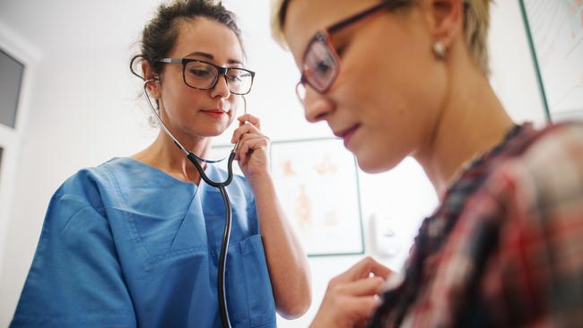 Female middle-aged doctor using stethoscope to examine patient. Picture: iStock.