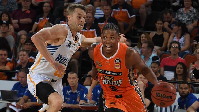 Taipans guard Scott Machado drives past Brisbane Bullets rival Nathan Sobey in the 94-85 win in Cairns on Saturday night.