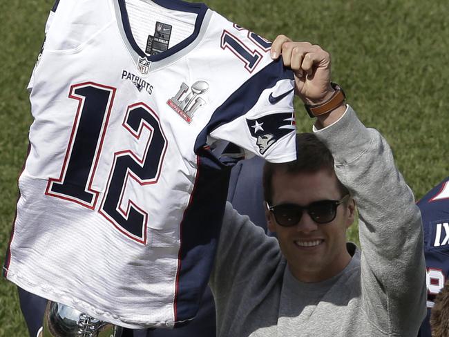 New England Patriots quarterback Tom Brady displays his recovered jersey, which was stolen from the locker room after the Patriots' February Super Bowl victory over the Atlanta Falcons in Houston, during pre-game ceremonies before a baseball game between the Boston Red Sox and the Pittsburgh Pirates on opening day at Fenway Park, Monday, April 3, 2017, in Boston. (AP Photo/Steven Senne)