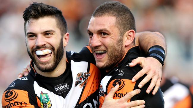 Tigers James Tedesco and Robbie Farah celebrate Tigers Martin Taupau scoring a try during the NRL game between the Wests Tigers and the New Zealand Warriors at Campbelltown Stadium , Campbelltown.Picture Gregg Porteous