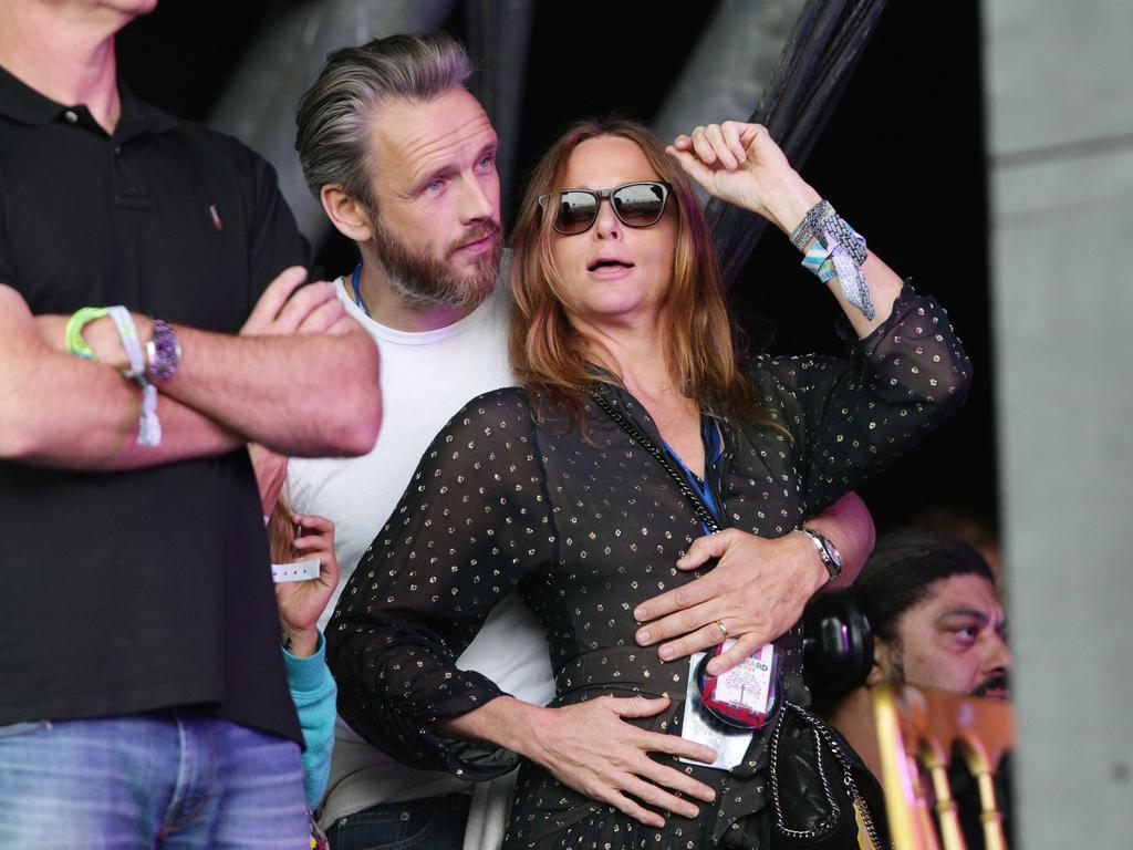 Stella McCartney with her husband Alasdhair Willis watching Pharrell Williams performing on The Pyramid Stage at the 2015 Glastonbury Festival. Picture: AAP