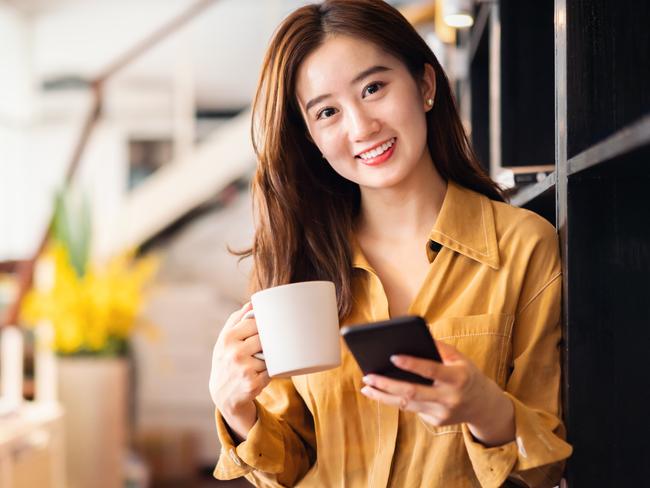 Cheerful Asian businesswoman in office.