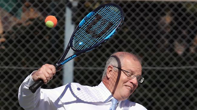 Prime Minister Scott Morrison dodges a tennis ball.