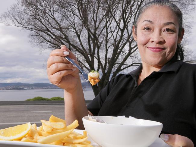 Manning reef cafe staff member Titim Wahyuni with some of Manning Reef's Tasmania Scallop dishes.