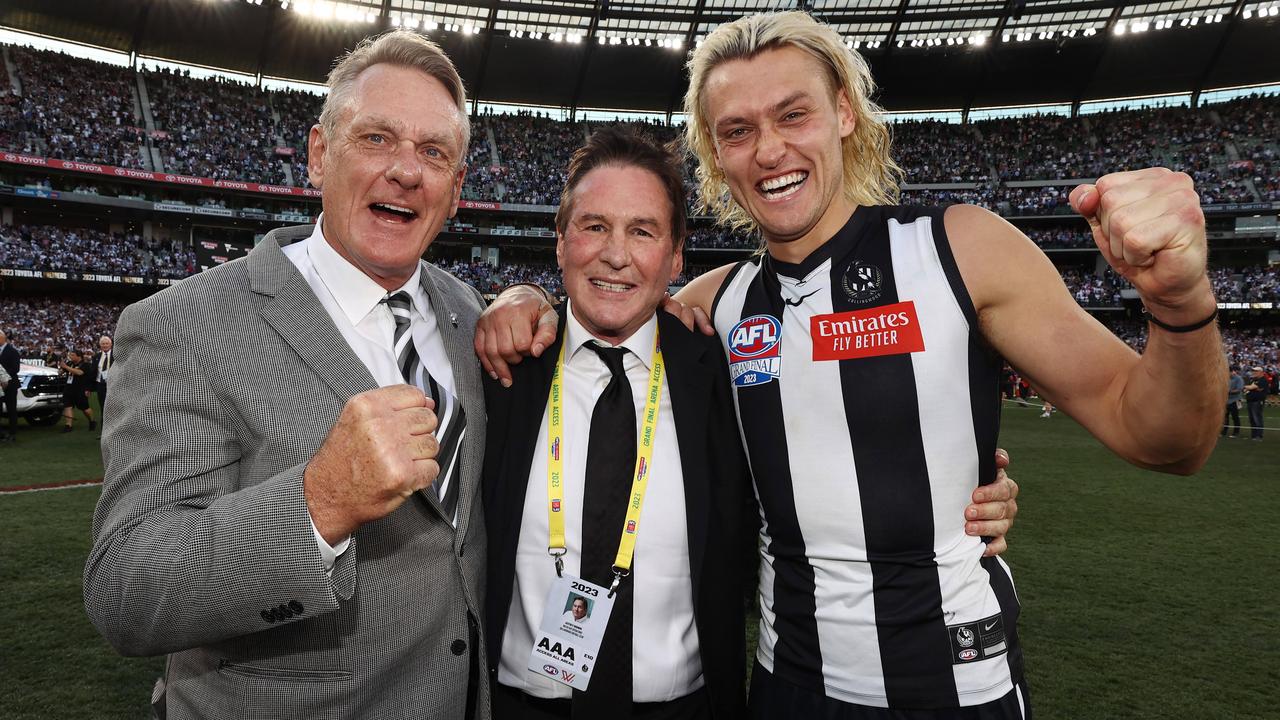 Jeff Browne with Darcy and Peter Moore in the moments after the final siren. Picture: Michael Klein