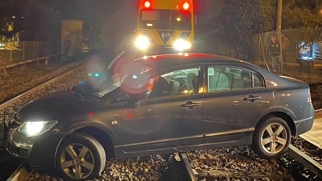 A woman has escaped unharmed after driving her car onto train tracks at Essendon station.