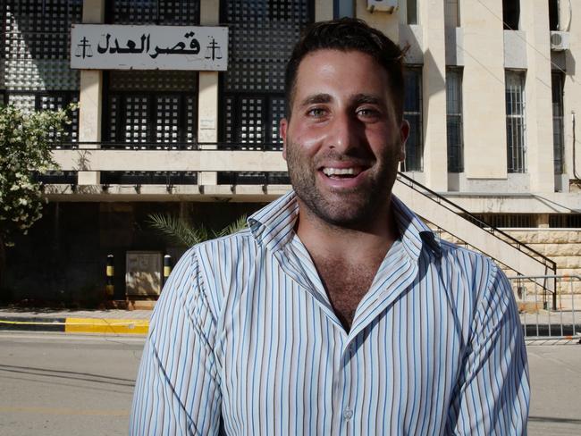 Deal ... Ali Elamine laughing while posing for a photo after deal was reach between all parties, outside the Palace of Justice, Baabda, Lebanon. Picture: Liam Kidston.