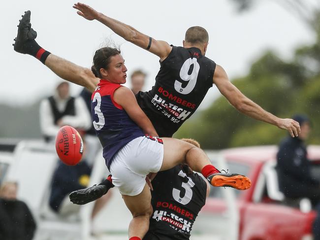 Frankston Bombers playing-coach Beau Muston (No.9) flies for a mark with Mt Eliza’s Harrison Scott and Bomber (No.3) Sam Pickess. Picture: Valeriu Campan