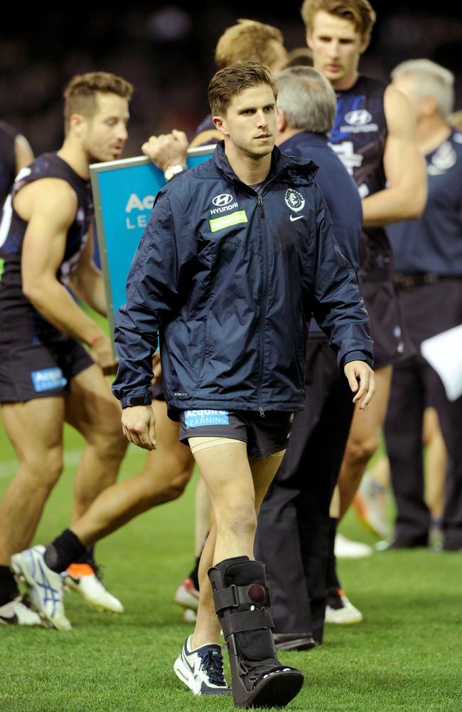 Marc Murphy walks off the ground in a moon boot. Picture: AAP