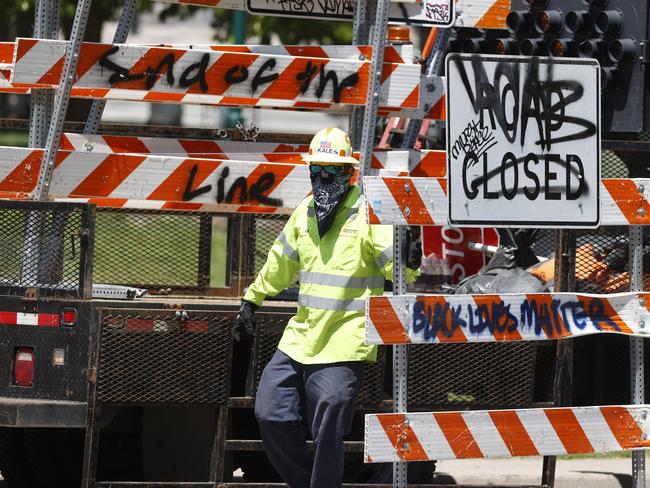 A worker collects barricades along Lincoln Avenue in Denver. Picture: AP