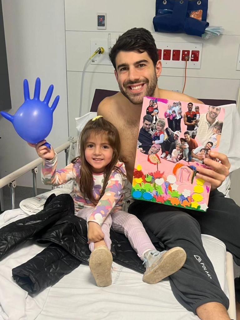 Melbourne AFL player Christian Petracca in hospital with his niece. Picture: Instagram