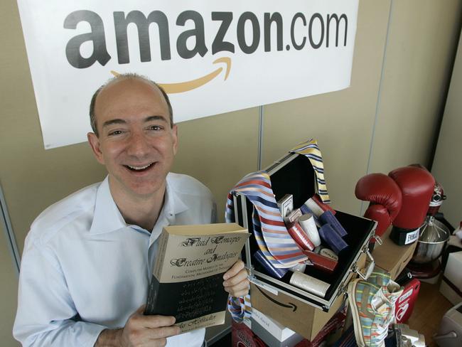 Amazon.com chief executive and founder Jeff Bezos holding a copy of "Fluid Concepts and Creative Analogies", the first book sold online by Amazon.com in Seattle 1995.