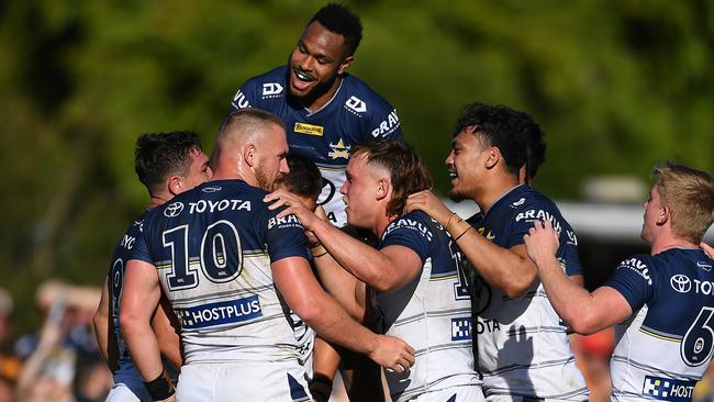 Scott Drinkwater of the Cowboys celebrates with team mates after scoring a try during the round 21 NRL match between the Canterbury Bulldogs and the North Queensland Cowboys at Salter Oval, on August 07, 2022, in Bundaberg. The Canterbury-Bankstown Bulldogs have released their final round of tickets for the upcoming game in Bundaberg against the Redcliffe Dolphins.(Photo by Albert Perez/Getty Images)