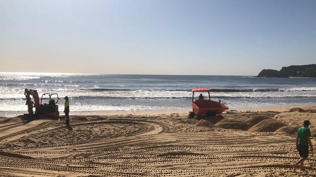 Contractors are brought in to build up beach for volleyball tournament after half of it was washed away. Picture: Julie Cross