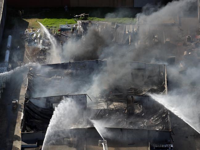 Firefighters battling a large factory Fire in Campbellfield, releasing toxic fumes into the air. Picture: Alex Coppel.