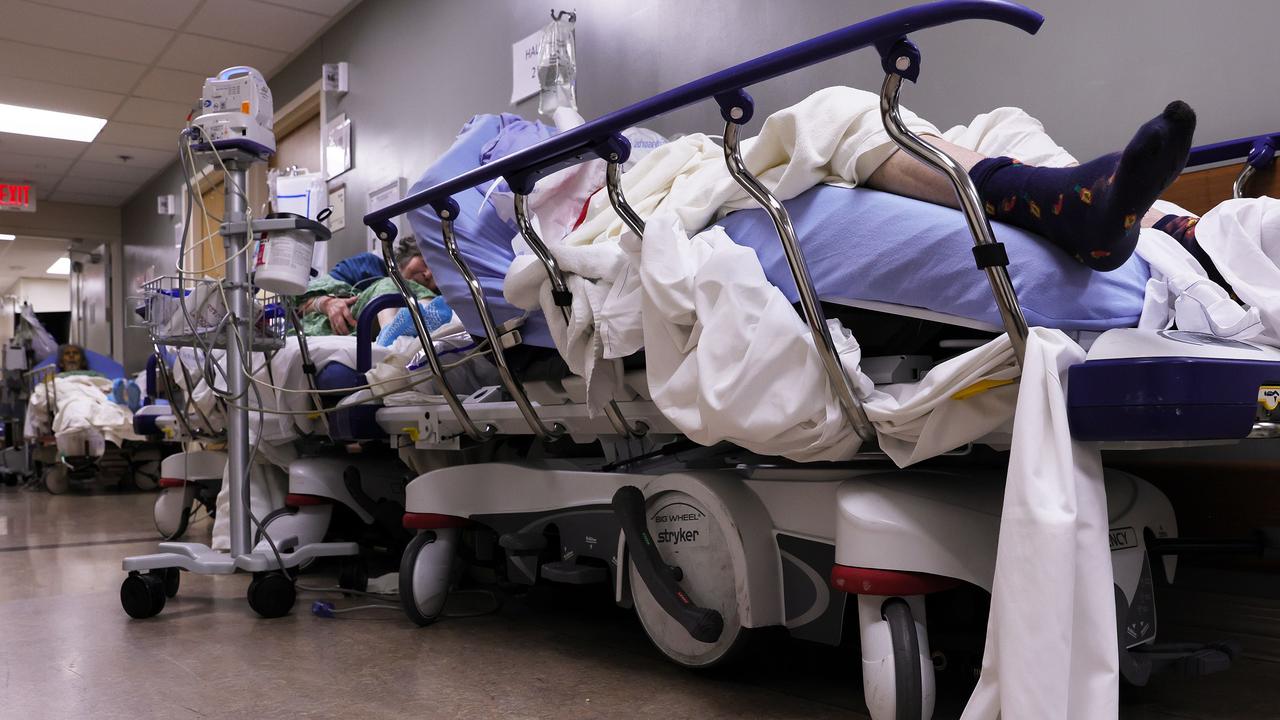 Patients lie on stretchers in a hallway in the overloaded emergency room in the US. Picture: Mario Tama/Getty Images/AFP