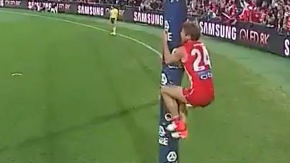 Dane Rampe jumps on the goalpost.