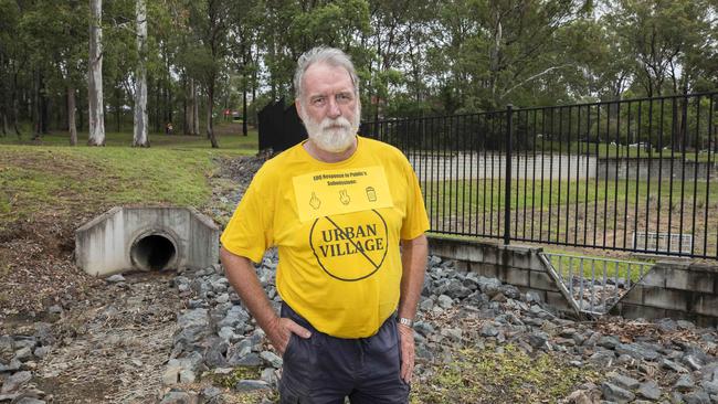 Ken Hegerty is angered by the new development in Carseldine. Ken poses for a photograph in front of the existing bioretention basin that will be demolished and not replaced. PICTURE: AAP/Renae Droop.