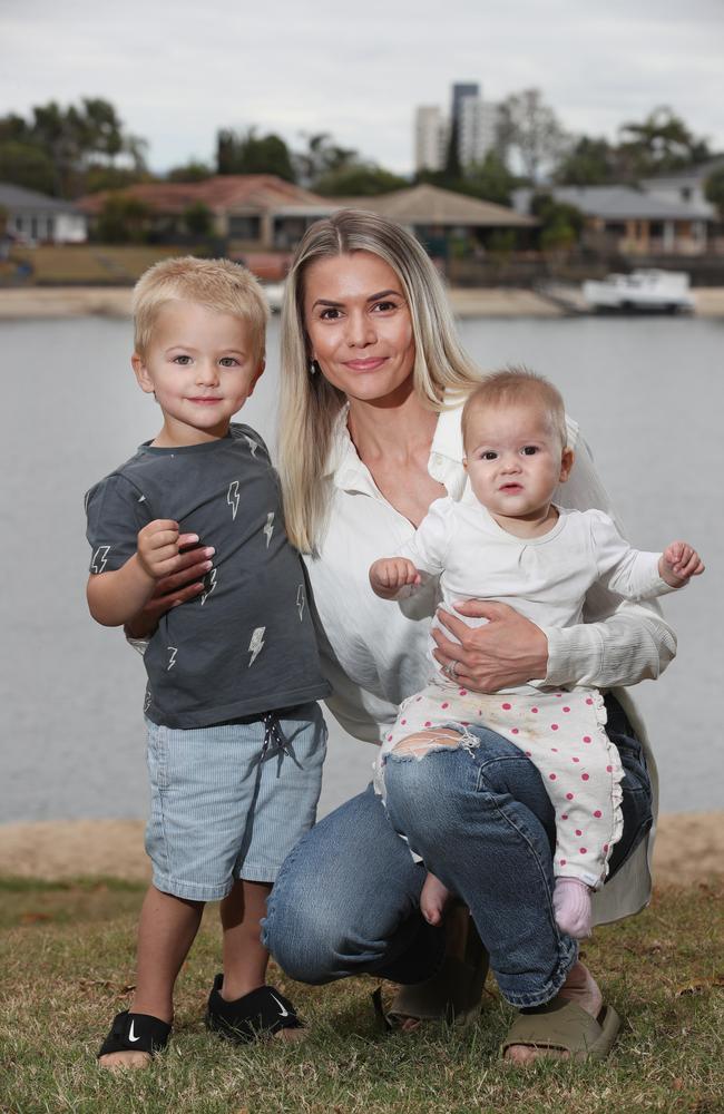 Dani Slade with her children Jordy, 2 (L) and Evie, 7 months (R) at Mermaid Beach. Picture: Glenn Hampson