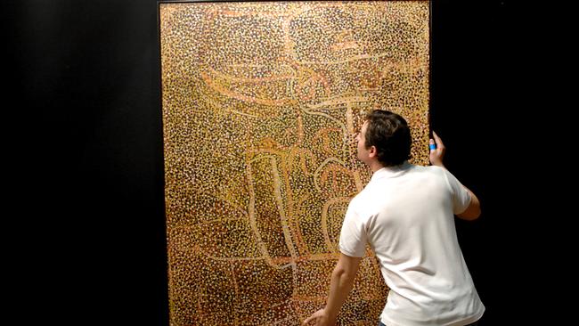 Sotheby’s Aboriginal Art Auction at the Museum of Contempary Art. A man adjust Emily Kame Kngwarreye: Alhalkere_Old Man Emu with Babies.