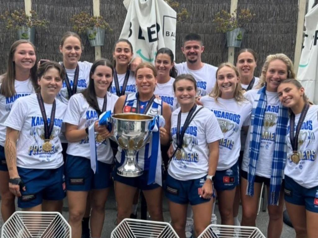 Ryan Pendlebury with North Melbourne AFLW players and the premiership cup. Picture: Supplied