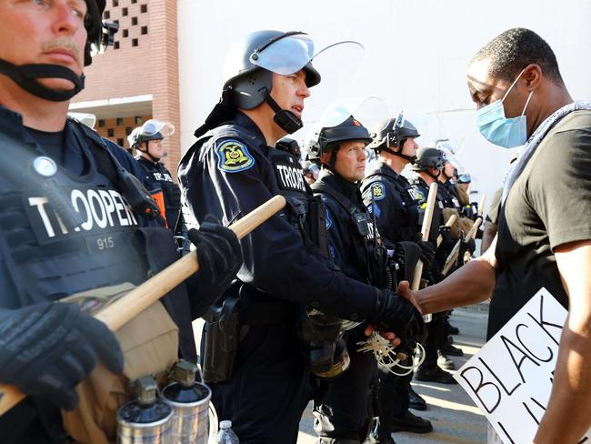 The officer and protester shake hands. Picture: AFP