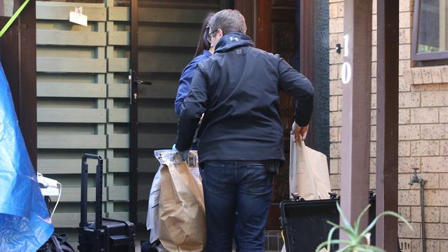 Police with evidence bags at an address in Chiswick Road, Greenacre. Picture: John Grainger