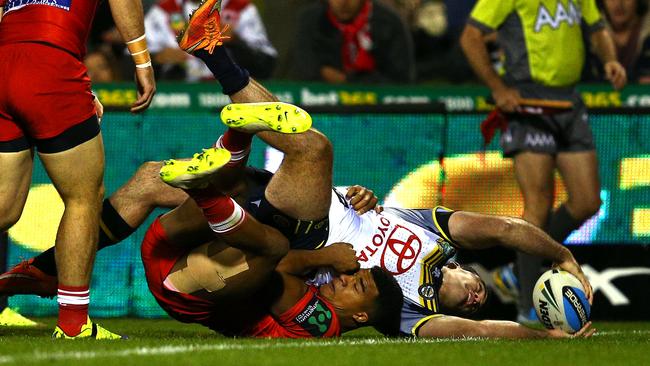 Kane Linnett of the Cowboys scores a try in the tackle of Kiti Glymin.