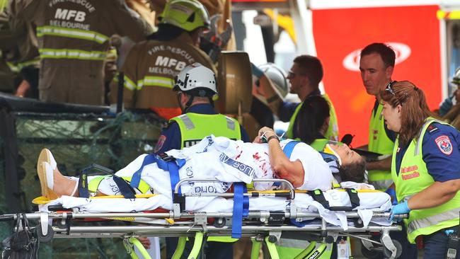 A passenger is rescued from the bus. Picture: Hamish Blair