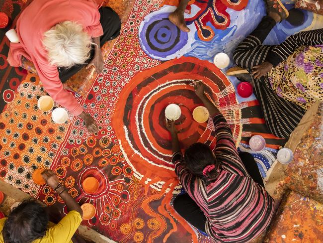 APY women artists painting the 2018 Women's Regional Collaborative. Picture: APY Art Centre Collective