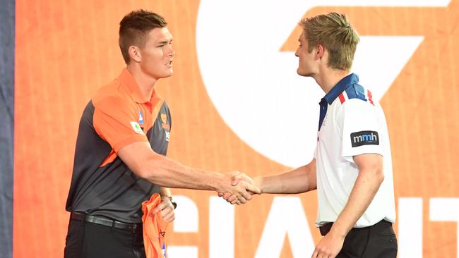 Central District’s Jackson Hately is welcomed to the Giants by Adam Tomlinson at Marvel Stadium. Picture: AAP Image/James Ross