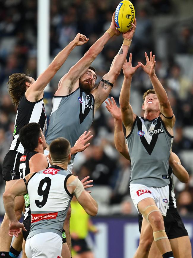 Charlie Dixon flies against the Pies.