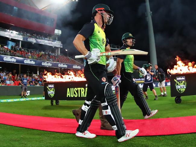 Australia's Chris Lynn and Aaron Finch walk out to bat during the T20 International match between Australia and South Africa, at Metricon Stadium, on the Gold Coast, Saturday, November 17, 2018. (AAP Image/Jason O'Brien)  NO ARCHIVING, EDITORIAL USE ONLY, IMAGES TO BE USED FOR NEWS REPORTING PURPOSES ONLY, NO COMMERCIAL USE WHATSOEVER, NO USE IN BOOKS WITHOUT PRIOR WRITTEN CONSENT FROM AAP