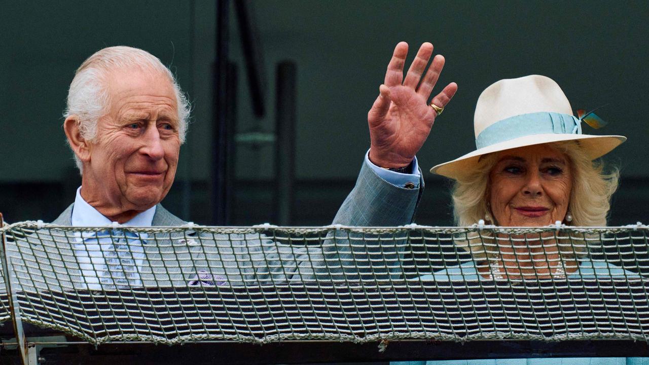 King Charles III and Queen Camilla wave at the Epsom Derby Festival horse racing event in May. Picture: BENJAMIN CREMEL/AFP