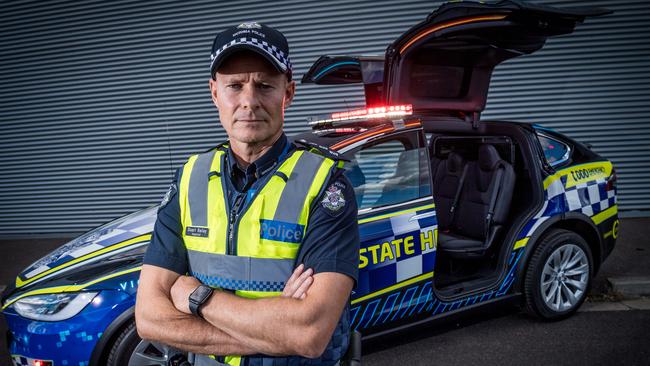 Inspector Stuart Bailey with the new Tesla patrol car. Picture: Jake Nowakowski