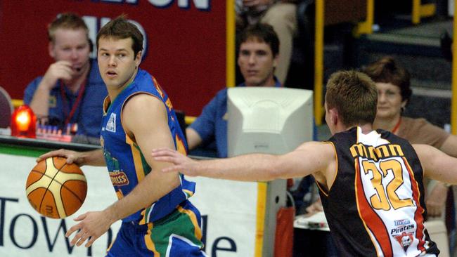 Townsville Crocs vs Hunter Valley Pirates at The Swamp, Townsville. 13 Nov 2004. PicMichael/Chambers. Crocs Kelvin Robertson chased by Pirates Brendan Mann. sport basketball action