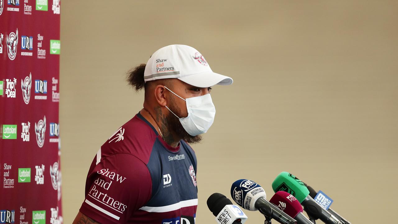 Addin Fonua-Blake is seen wearing a face mask as he talks to the media