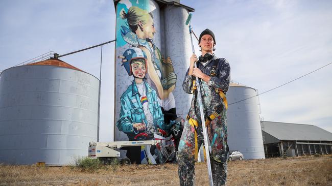 Artist Kitt Bennett and his work on Albacutya’s old grain silo in north western Victoria. Picture: Alex Coppel.