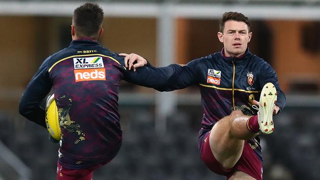 Lachie Neale, right, warms up before the Round 5 clash with the Power. Picture: Jono Searle/AFL Photos