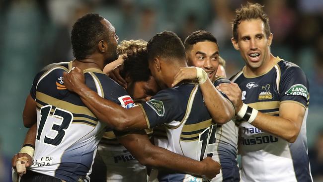 Henry Speight of the Brumbies celebrates with his teammates after scoring a try.