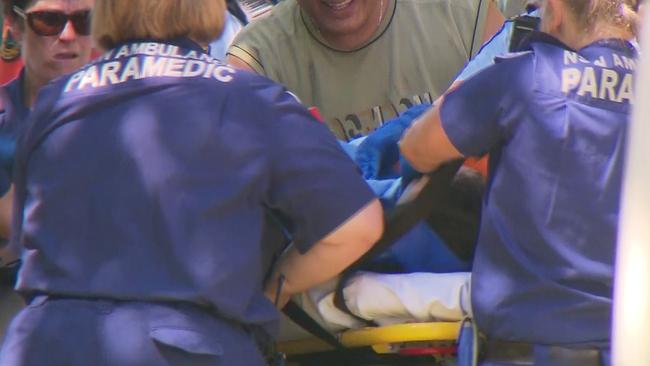 Paramedics work on one of the men. Picture: TNV. 