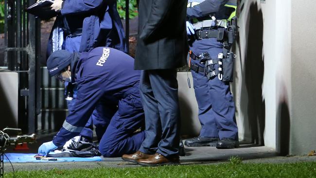 The forensic team secures the area outside the apartment. Picture Yuri Kouzmin