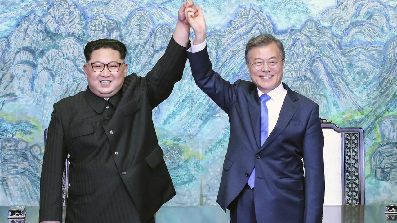 Could North Korean leader Kim Jong-un, left, and South Korean President Moon Jae-in held hands if Donald Trump hadn’t pushed them together? Picture: Korea Summit Press Pool/AP
