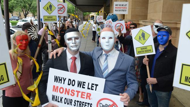 “B”, left, and “A”, right, with their supporters outside the District Court. Picture: AAP/Brenton Edwards.