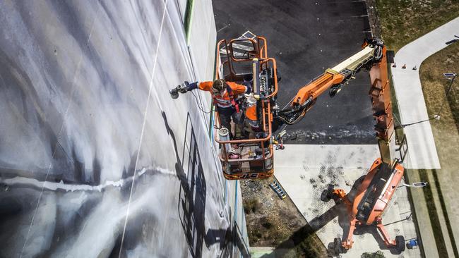 Mr van Helten paints the mural. Picture: NIGEL HALLETT