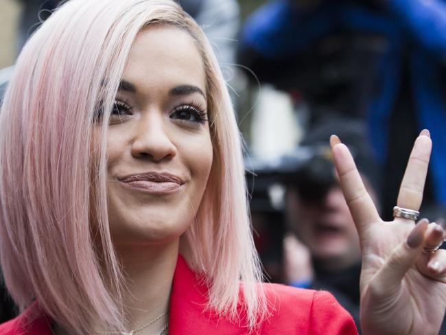 British singer Rita Ora arrives at a west London studio to record the new Band Aid 30 single on November 15, 2014. Bob Geldof, One Direction, Bono and some 30 other stars gathered in a studio in London on Saturday to record a 30th anniversary version of the Band Aid charity single to raise money to fight Ebola. Led Zeppelin's Robert Plant, Coldplay's Chris Martin and Sinead O'Connor were also among the rockers brought together by Geldof to sing the fourth version of "Do They Know It's Christmas?" Musicians began arriving in the early morning and were expected to record all day and into the night before the single is aired for the first time on Sunday and then officially released on Monday. AFP PHOTO / ANDREW COWIE