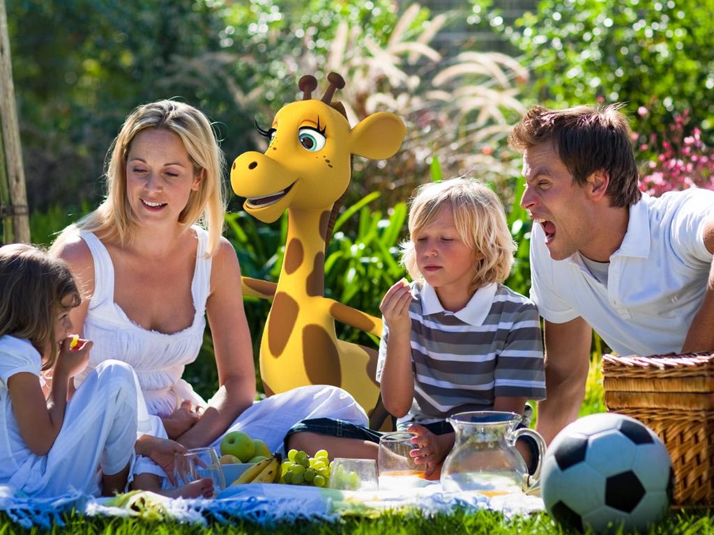 Healthy Harold and a family enjoy a picnic of healthy food.