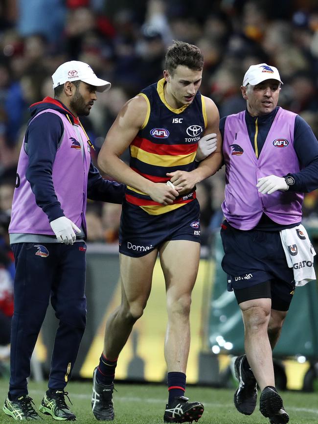 Tom Doedee leaves the field after a crunching collision with Jed Anderson. Picture Sarah Reed