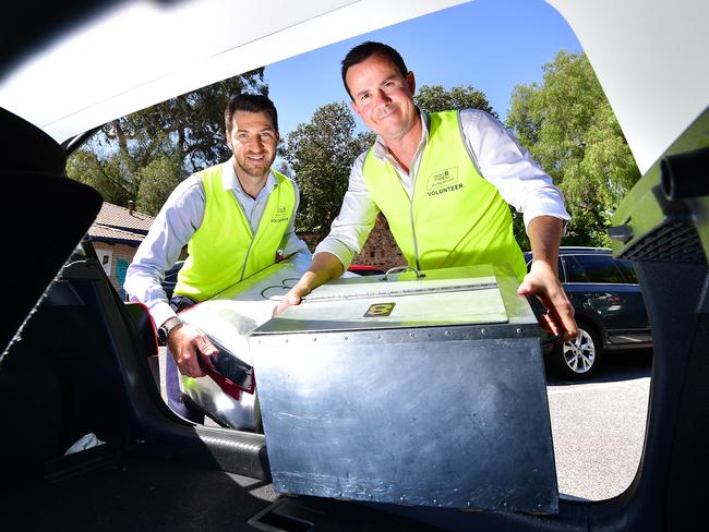 MRS Property senior consultant Sam Tucker and director Michael Rouvray deliver for Meals on Wheels as part of a corporate volunteering commitment. Picture: AAP/Mark Brake