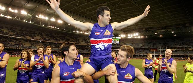 Lindsay Gilbee is chaired off Etihad Stadium after playing his 200th game for the Doggies.